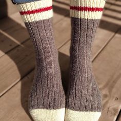 the legs and ankles of a person wearing socks with red, white, and blue stripes