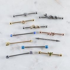 six different types of piercings on a marble surface