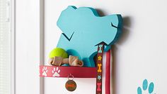 a blue bear is hanging on the wall