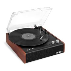 an old record player with its turntable and clear plastic cover on it's wooden stand