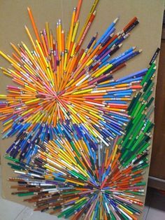 a bunch of pencils are arranged in the shape of a starburst on a cardboard box