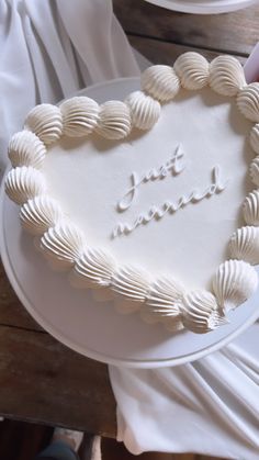 a heart shaped cake with the words just married written on it in white frosting