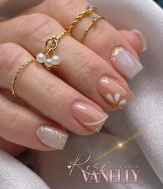 a woman's hand with french manies and gold rings on her fingers, decorated with pearls