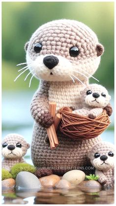 a crocheted otter holding a nest with two baby otters sitting on it