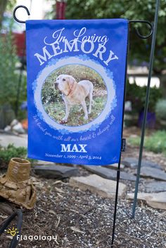 a blue memorial flag with a photo of a dog on it and the words, loving memory