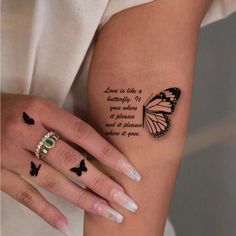 a woman's arm with a butterfly tattoo on the left side of her body
