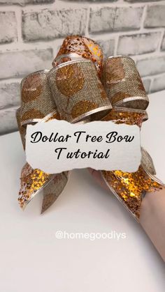 a hand holding a small bow with gold sequins on it and the words dollar tree bow