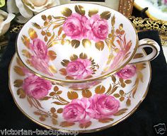 two cups and saucers with pink flowers on them