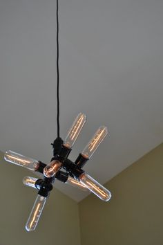a chandelier hanging from the ceiling in a room with light bulbs on it