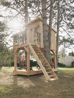 a tree house built into the side of a tree with stairs leading up to it