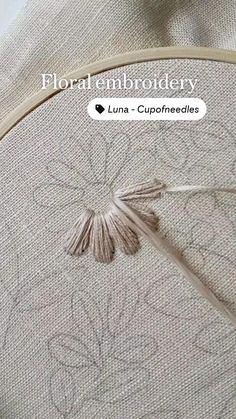 an embroidery project with the words floral embroidery written in white and on top of it
