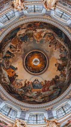 an ornate dome with paintings on the ceiling