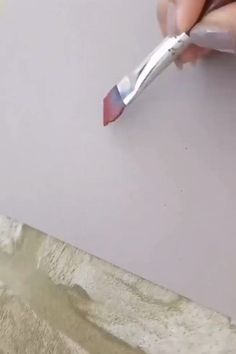 a person is using a pen to draw something on the paper with it's tip