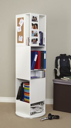 a white book shelf with books and binders
