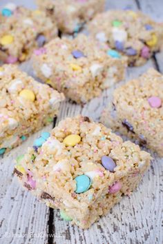 rice krispy treats are stacked on top of each other with candy and sprinkles