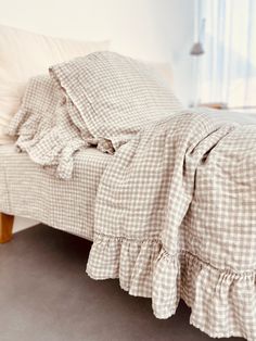 a bed with a checkered comforter and pillows