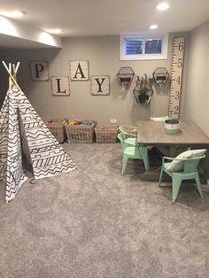 a child's playroom with a teepee tent and toys