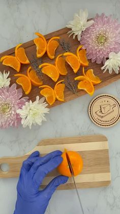 orange slices and flowers on a cutting board