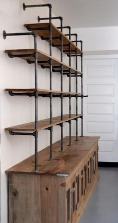 a wooden shelf with metal pipes on it