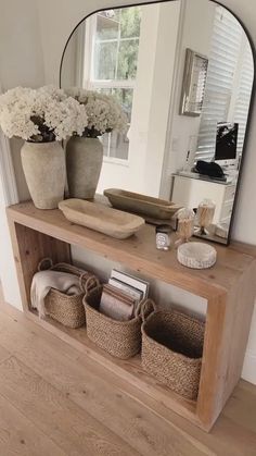 a mirror and some baskets on a shelf