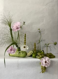 various flowers and plants are arranged on a table