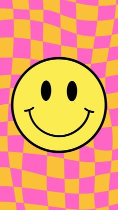 a yellow smiley face with black eyes on a pink and orange checkerboard background