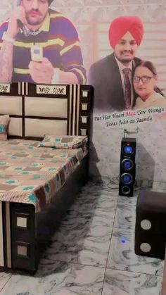 a bed room with a neatly made bed and speakers