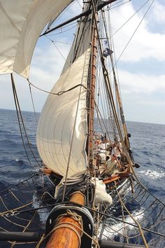 an old sailing ship in the open ocean