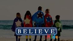 children standing in front of the ocean with their capes on and believe kids logo