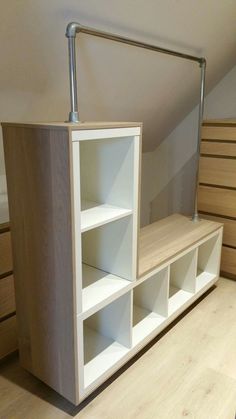 a white shelf sitting in the middle of a room next to some drawers and shelves