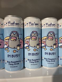 four cans of i'm busy blue raspberry fizzy drink on a shelf