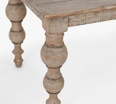 an old wooden table with turned legs on a white background