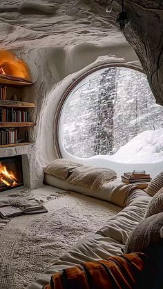 a bedroom with a bed, fireplace and bookshelf in the corner that looks like a cave