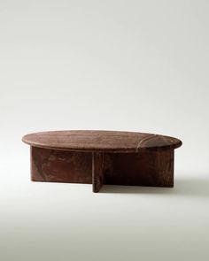 an oval table with a wooden base and marble top