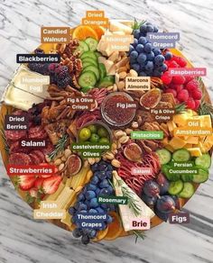 a plate filled with different types of fruits and vegetables on top of a marble table