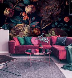 a living room with floral wallpaper and pink couches in front of a coffee table