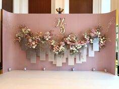 a pink backdrop with flowers and numbers on it
