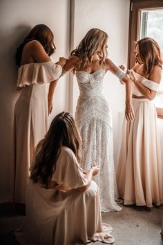 bridesmaids helping the bride get ready for her wedding