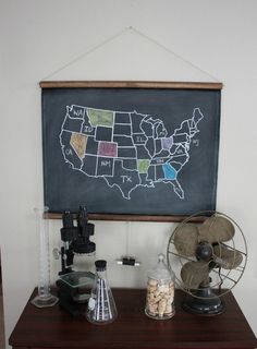 a blackboard with the united states on it and other items sitting on a table