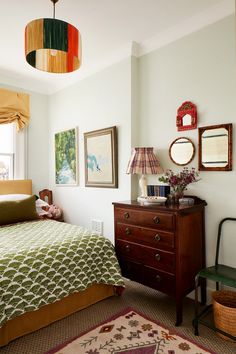 a bedroom with a bed and dresser in it