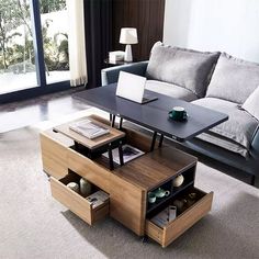 a living room with a couch, coffee table and open storage drawers on the floor