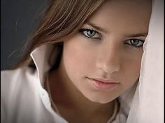 a beautiful young woman with blue eyes posing for the camera