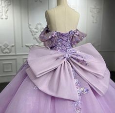 An exquisite Purple Quinceanera Gown graces the figure with a voluminous skirt of floral embellishments, a delicate hemline adorned with an intricate motif, and showstopping off-the-shoulder cuffs; further accentuated with an opulent oversized bow and ribbon lacing in back for a perfect fit. material: organza color: as shown type: party ball gown sweetheart neckline built in bra lace up back shown as size 2 original photos Outfits, Quince Dresses, Rapunzel, Quince Dress, Princess Evening Dress, Tulle Ball Gown, Purple Quinceanera Dresses, Hot Pink Quinceanera Dresses, Lilac Quinceanera Dresses