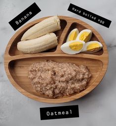 a wooden plate with eggs, bananas and oatmeal
