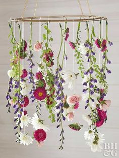 a mobile with flowers hanging from it's sides
