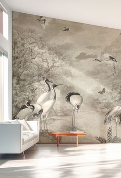 a living room scene with birds painted on the wall