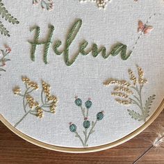 a close up of a embroidery on a hoop with the word helen written in it