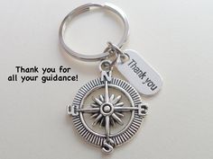 a silver compass keychain with thank you for all your guidance written on it