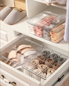 the drawers are organized with folded towels and other things in them, such as slippers