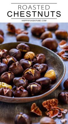 roasted chestnuts in a bowl on a table with nuts scattered around it and text overlay that reads roasted chestnuts